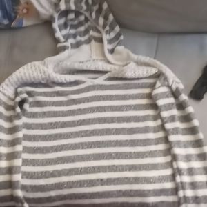 A gray & white striped laced hooded sweater.